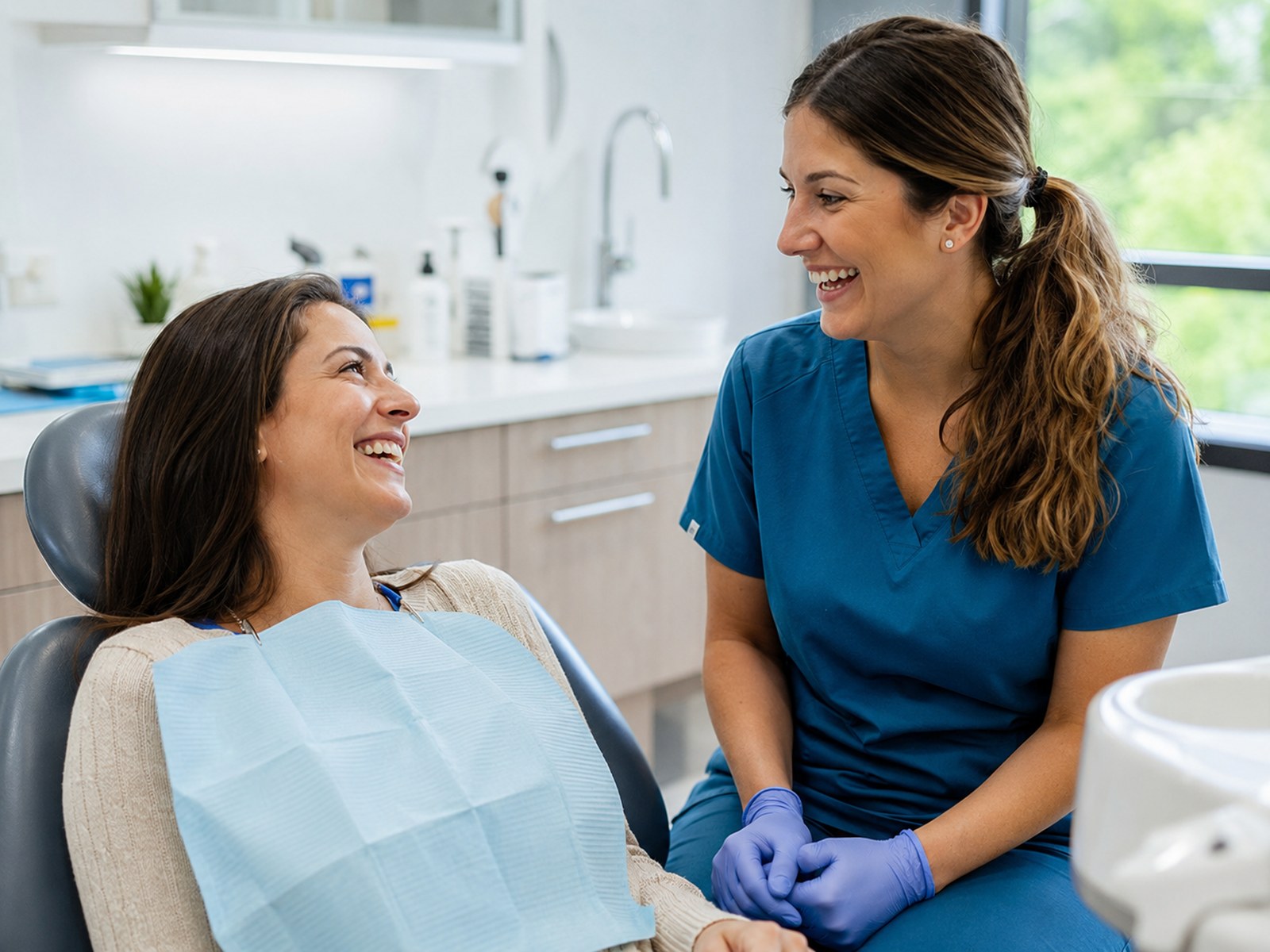 A hygienist sharing a laugh with a patient at Harborlight